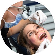 A dentist checking the teeth of a woman at Cottonwood Smiles