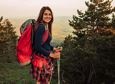 Shot of an attractive young woman trekking in the mountains